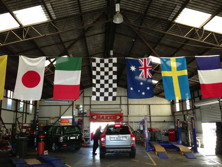 Inside the Tyre Select workshop with vehicles and workshop equipment.
